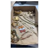 Gold tone woman's jewelry.  Brooches, earrings,