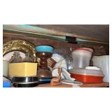 Shelf of miscellaneous Tupperware, dishes, and
