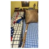 Full size bed with headboard and bedding.  Flags