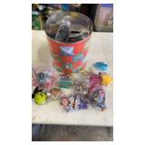 Popcorn tin full of miscellaneous happy meal kids