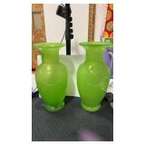 2 green glass vases  approximately 11 inches tall