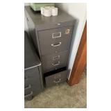 3 drawer metal filing cabinet.  Contents on top