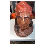 Wood carving of a native American bust John B