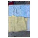 2 blue baby blankets and 1 yellow baby blanket