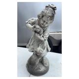 Garden sculpture featuring a girl holding a