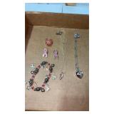 Womanï¿½s pink and silver tone necklaces , bracelet