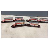 4 HO Scale Flat Cars with U-Haul Trucks on them