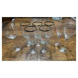 8 Wine Glasses.  5 with a Silver Tone Ring on