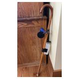 Wooden cane with horn and water bottle