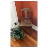 Wooden chair with artificial plant