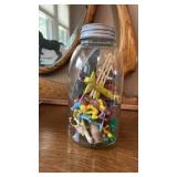 Jar with toy cowboys and Indians plastic toys and