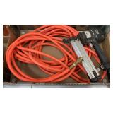 Orange Air Hose with Nail Gun.  Unknown length