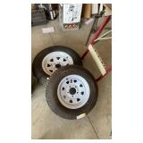 Two spare trailer tires with wheels both of them