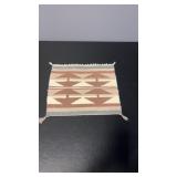Hand woven flat weave textile featuring a