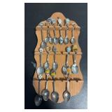Wooden holder and souvenir spoons