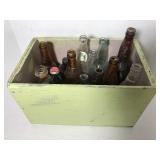 Painted wood crate full of old glass bottles