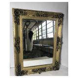Ornate mirror in gold plastic frame