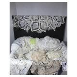 Basket of lace doilies, table cloths and runners