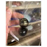 Two Black John Deere Marbles