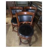 2 swiveling padded stools