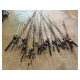 Large assortment of fishing poles and fish net
