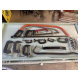 Assortment of clamps, handsaws, and pry bars