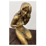 Nude kneeling woman statue