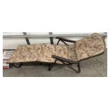 Outdoor lounge chair, rug, and tapestry suitcase