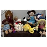 Assortment of stuffed dolls and doll chairs
