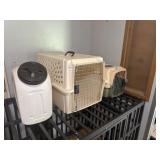 Two pet carriers and food container
