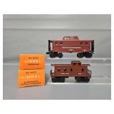 Two Mint Lionel Postwar O Cabooses in Original Boxes