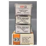 Four Micro-Trains and Con-Cor N Scale Freight Car in Clear Cases