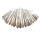 TWENTY ANTIQUE STERLING HANDLED BUTTON HOOKS
