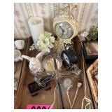 Flat of decorative desk clocks, candles, and