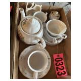 Flat of tea pot, cups, creamer, and saucers