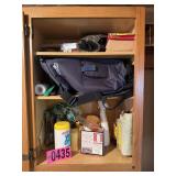 Contents of cabinet: cleaning supplies, backpack