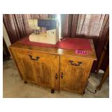 Rolling wooden sewing cabinet with