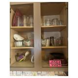 Cabinet contents: baking dishes, measuring cups,