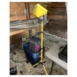 Portable halogen work light on tripod stand with