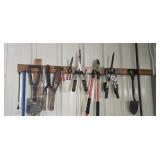 Assorted hand tools on rack