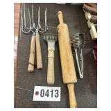 Group of vintage kitchen utensils: rolling pin,