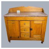 Brown marble-top wash stand with backsplash,