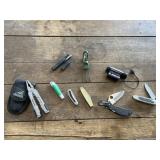 Assorted pocket knives, frog gigger, multi-tool,