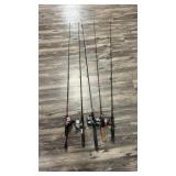 Five fishing poles with reels, including