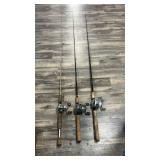 Three fishing poles with reels, including q