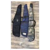 Three gun cases approximately 48 inches long