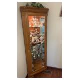 Lighted corner cabinet with glass shelves comes