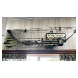 Compound bow with several arrows, camo bag, and