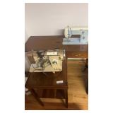 Two sewing machines, one with cabinet one is a