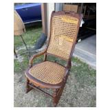Rocking chair, caned. Dark wood